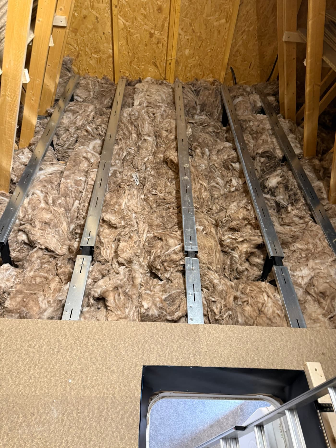Raised loft flooring fitted above the insulation on a modern trussed roof