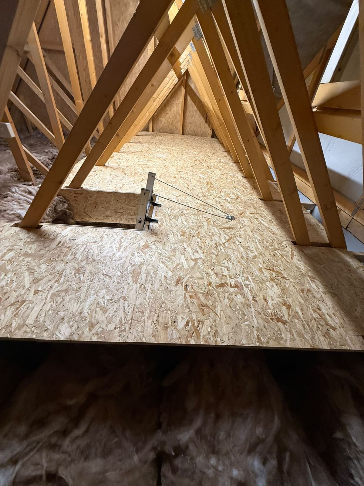 Edge of the raised loft floor sitting clear above the insulation