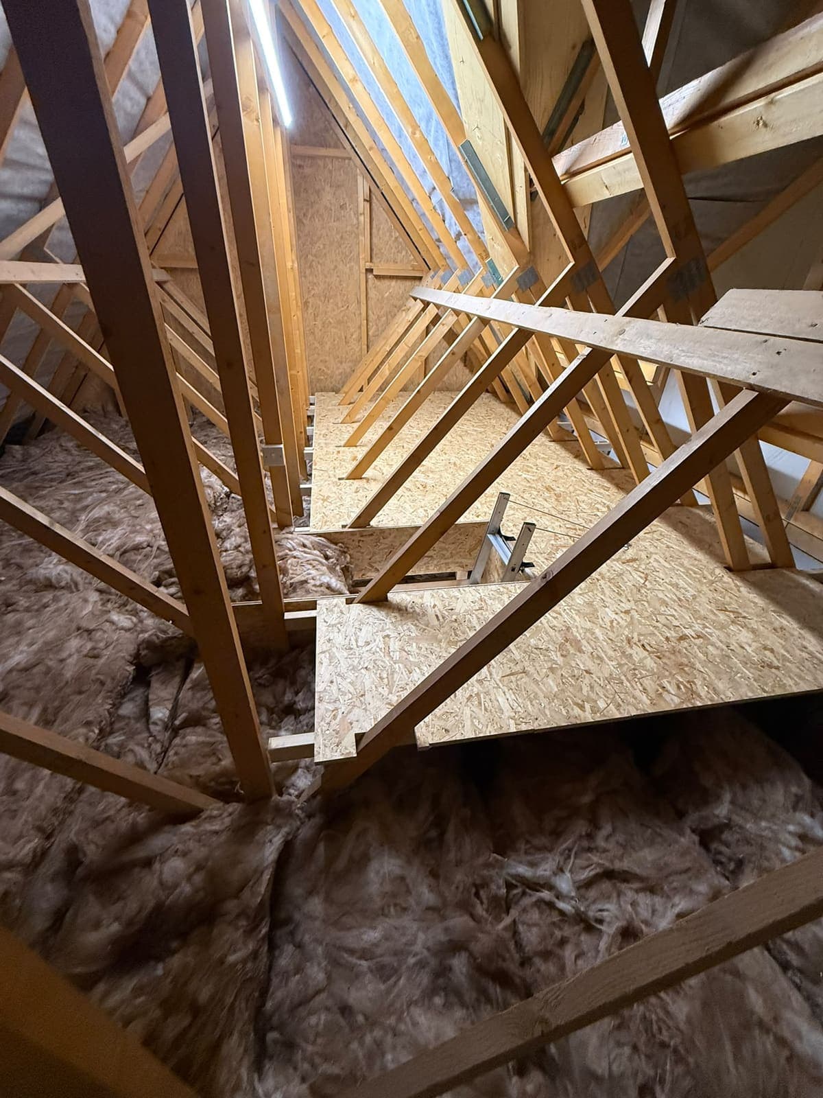 Boarded storage run between the roof trusses in a Rainham new build