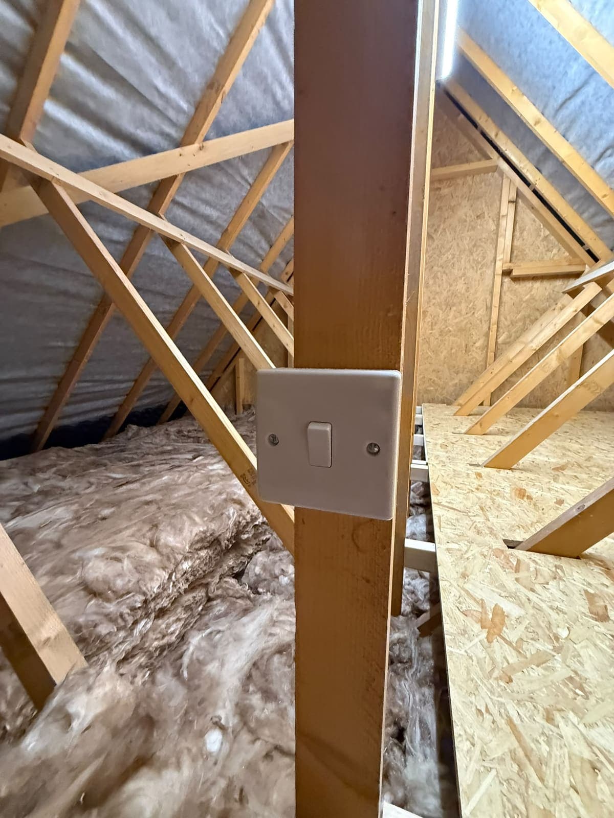 Loft light switch fitted to a truss beside the boarded floor