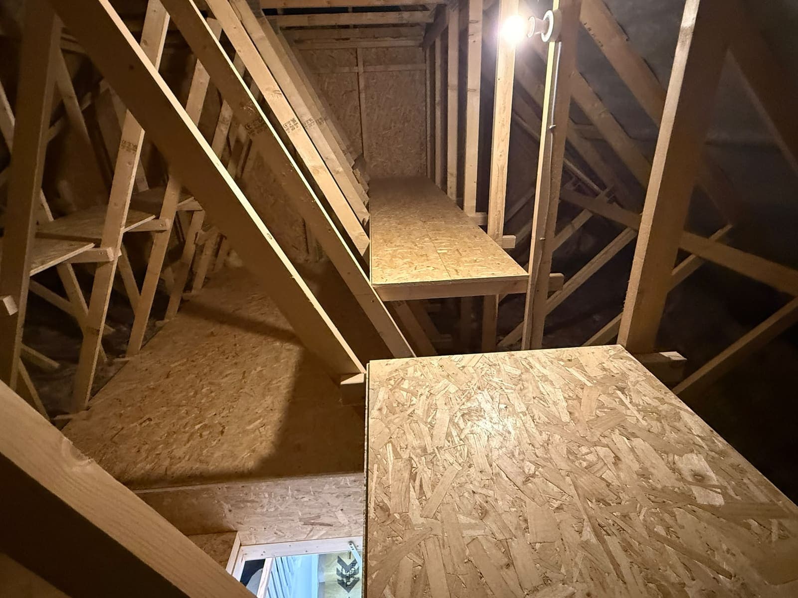 High-level loft shelf and boarded floor beside the hatch