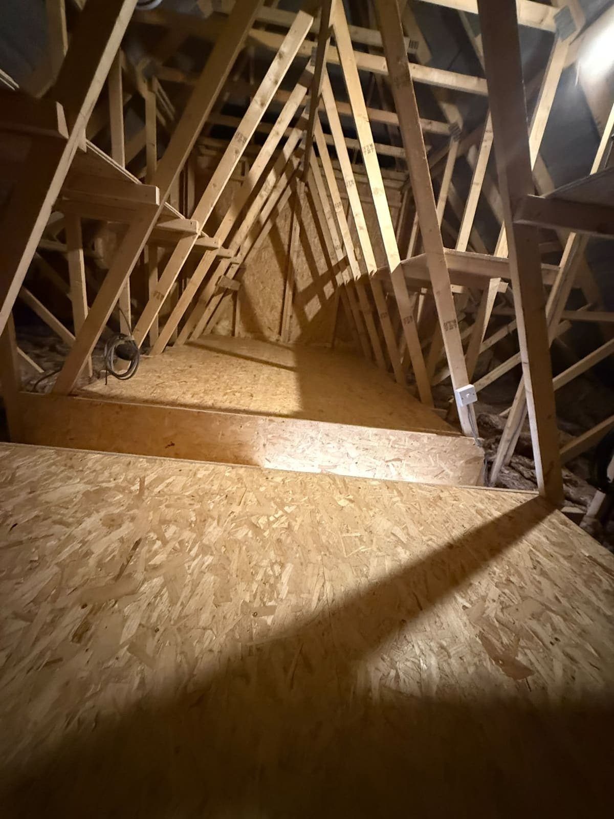 Finished loft boarding lit from the gable end