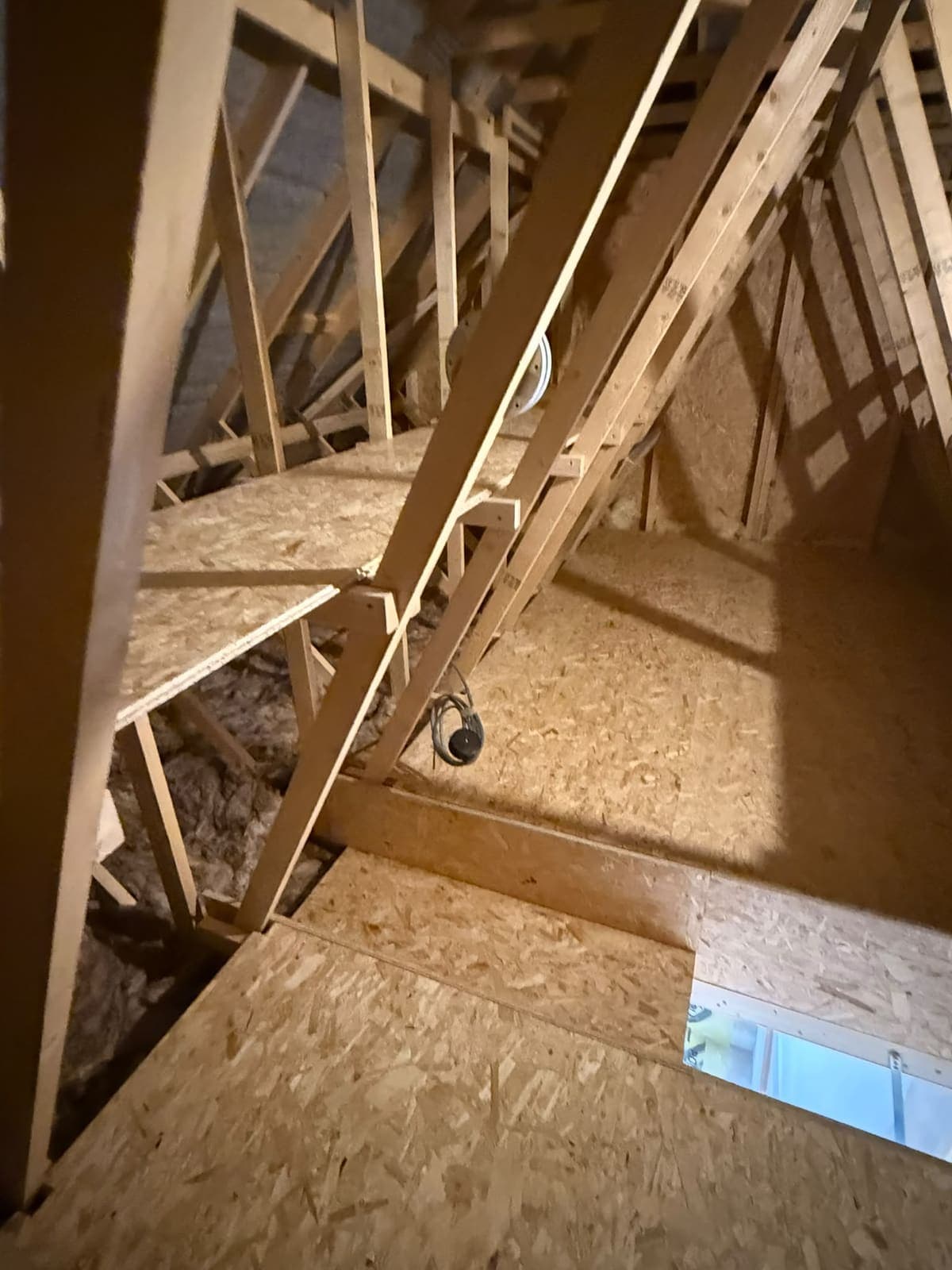 Loft shelf and boarded floor beside the hatch opening