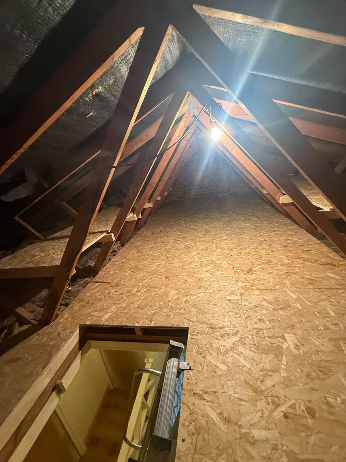 Boarded loft floor with the hatch and loft ladder