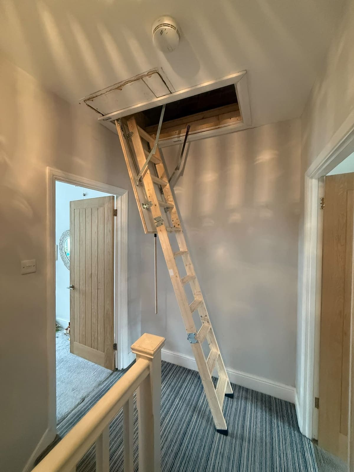 Folding loft ladder down on the landing