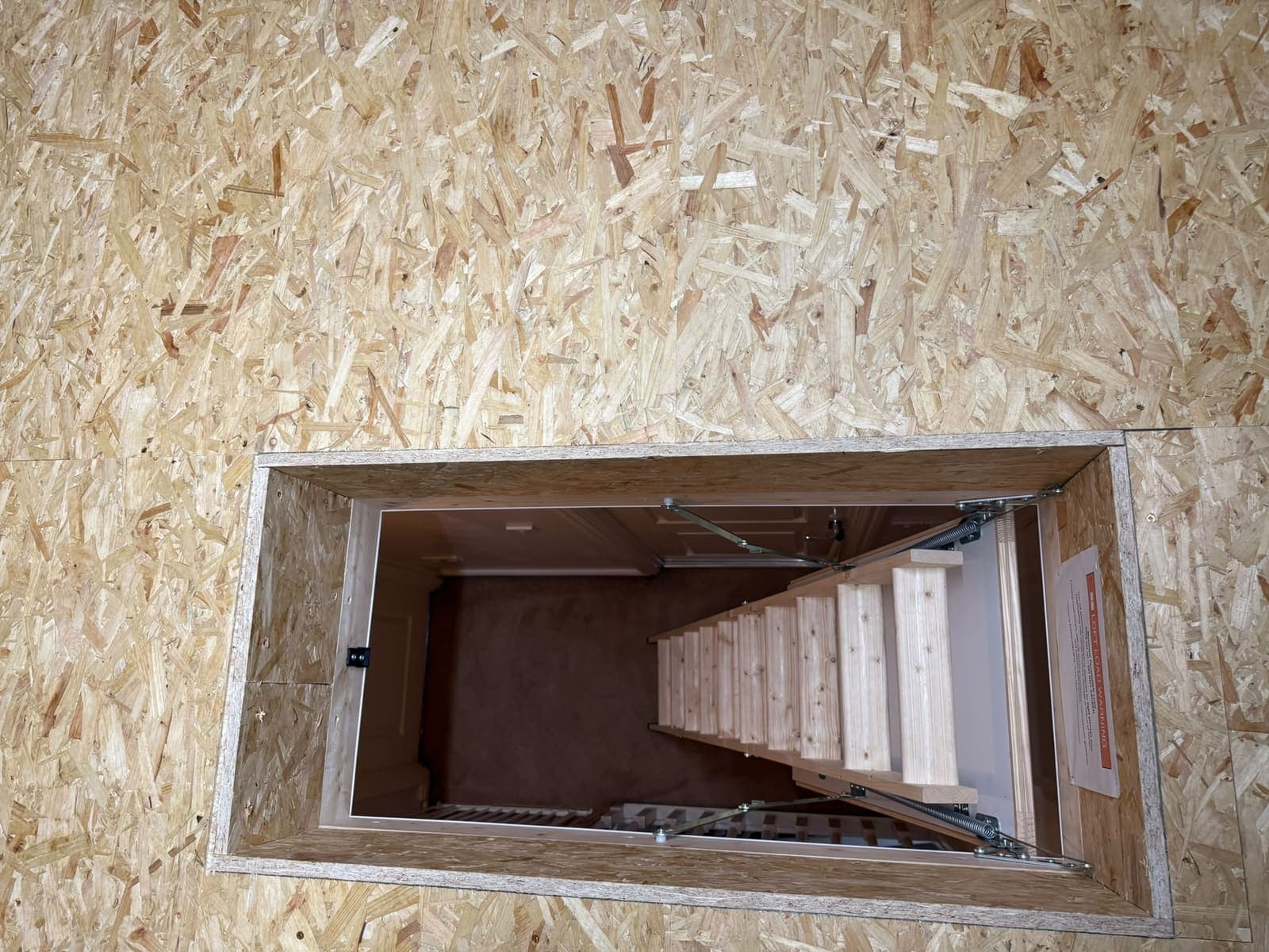 Looking down the new timber loft ladder through the lined hatch