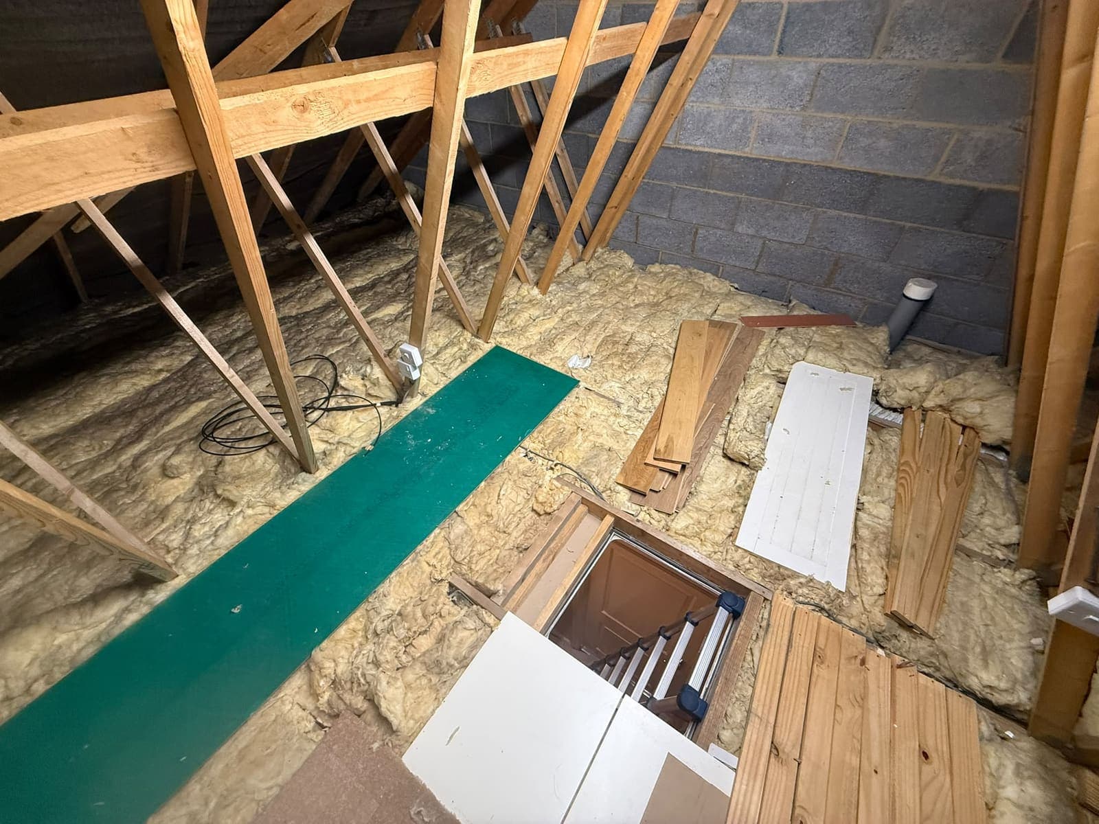 Before: the Chattenden loft with loose insulation and a single crawl board
