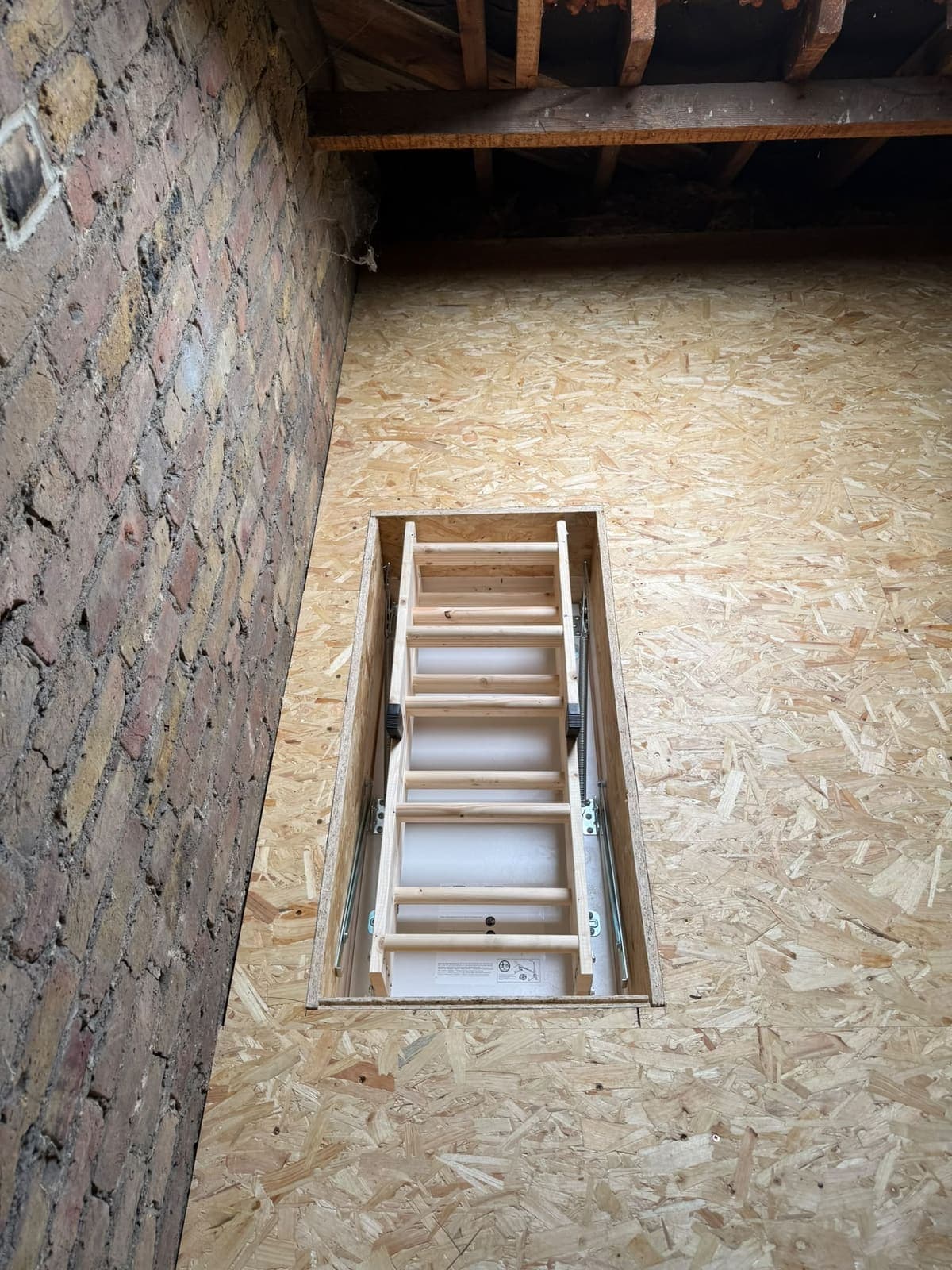 Deluxe wooden loft ladder folded away inside its lined hatch