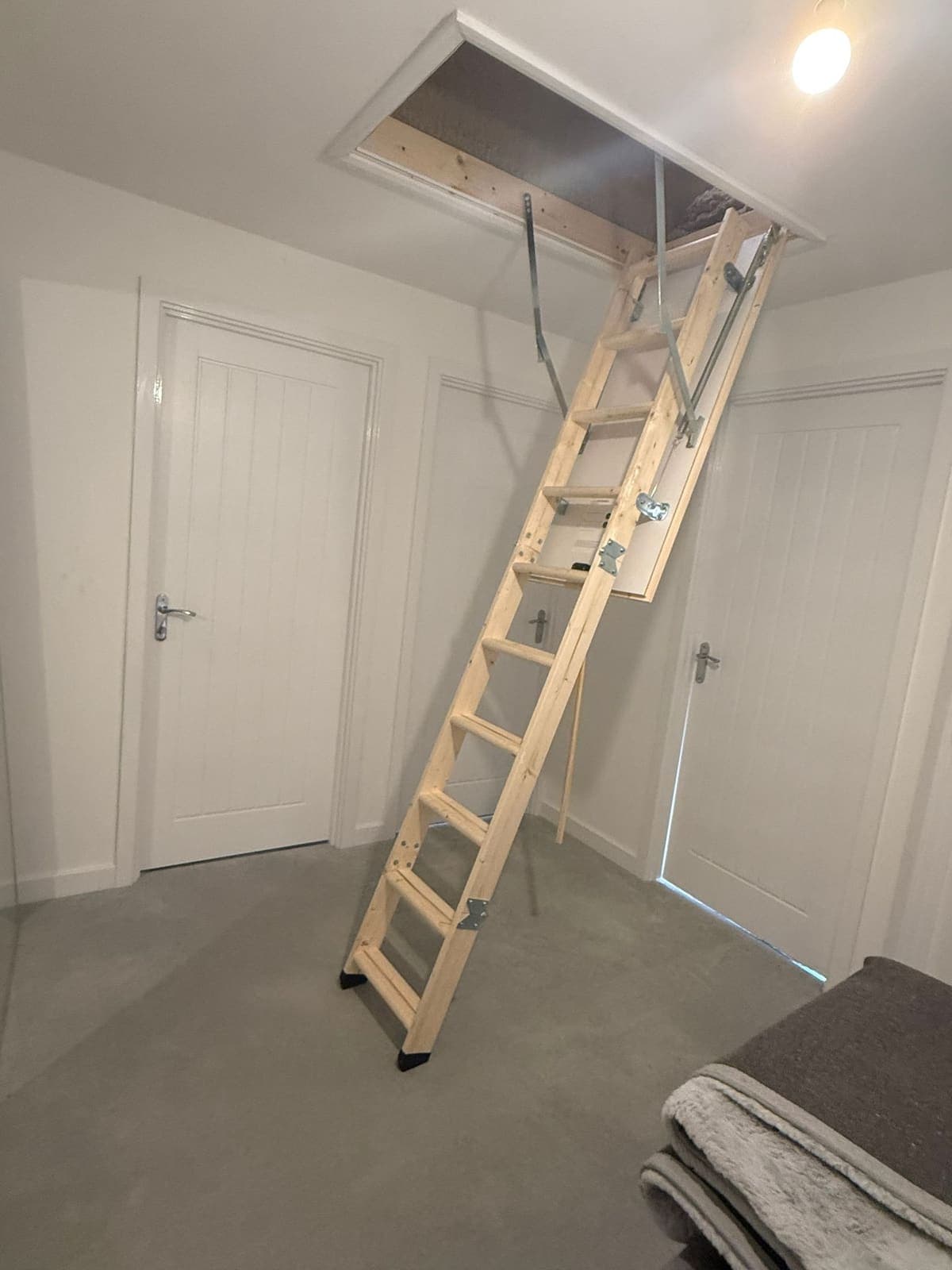 Wooden loft ladder fitted to the landing hatch