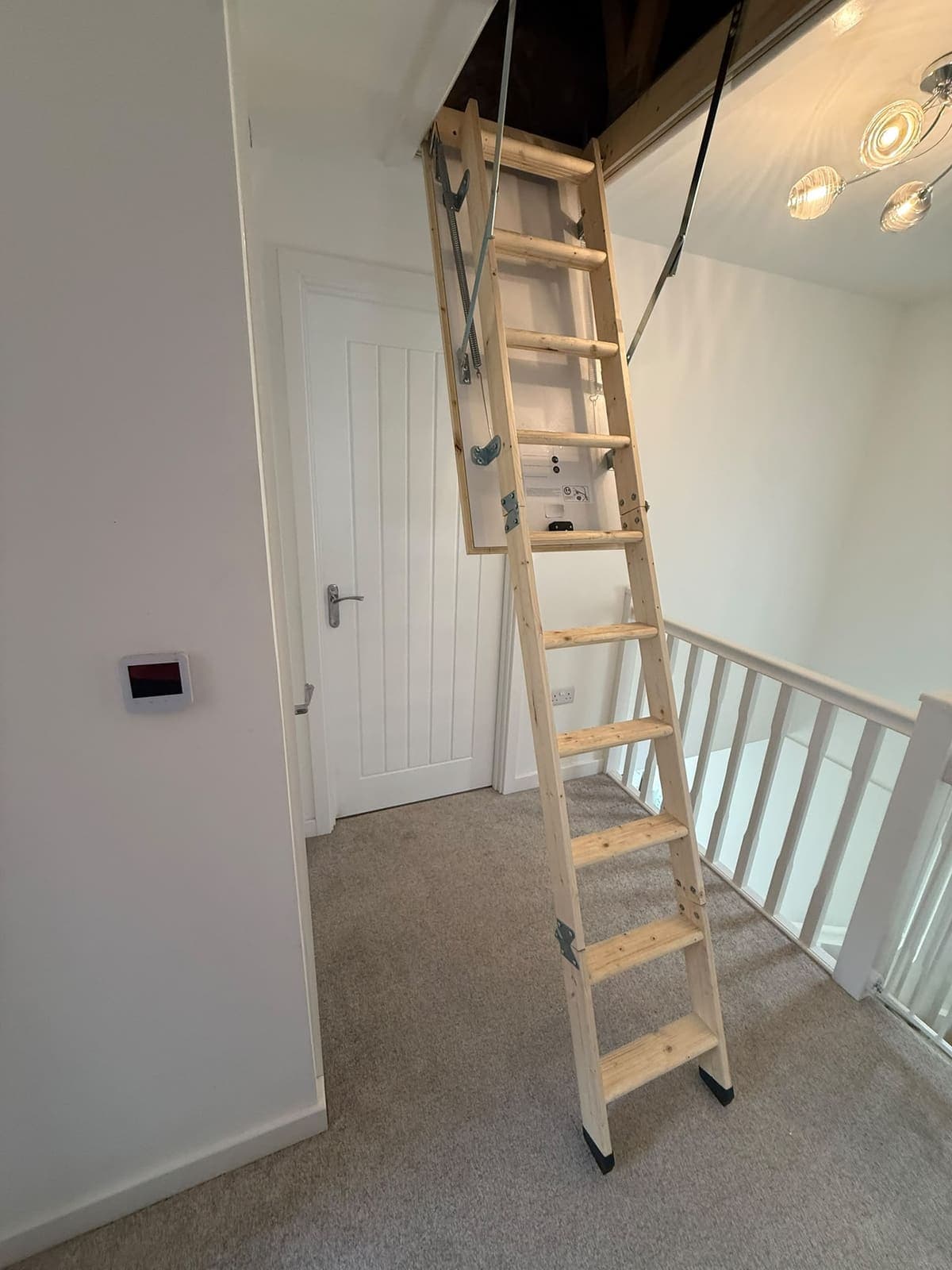 Wooden loft ladder fitted to the landing hatch