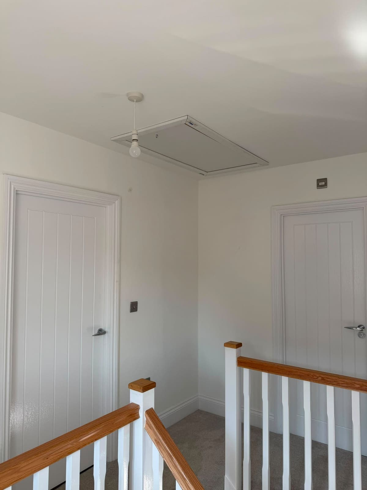 Loft hatch closed on the landing ceiling