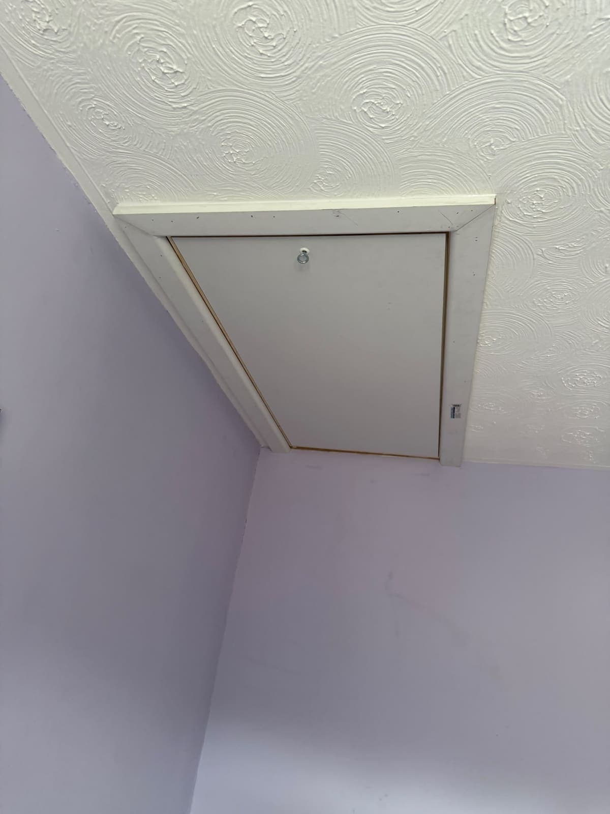 New loft hatch door closed and trimmed against the ceiling