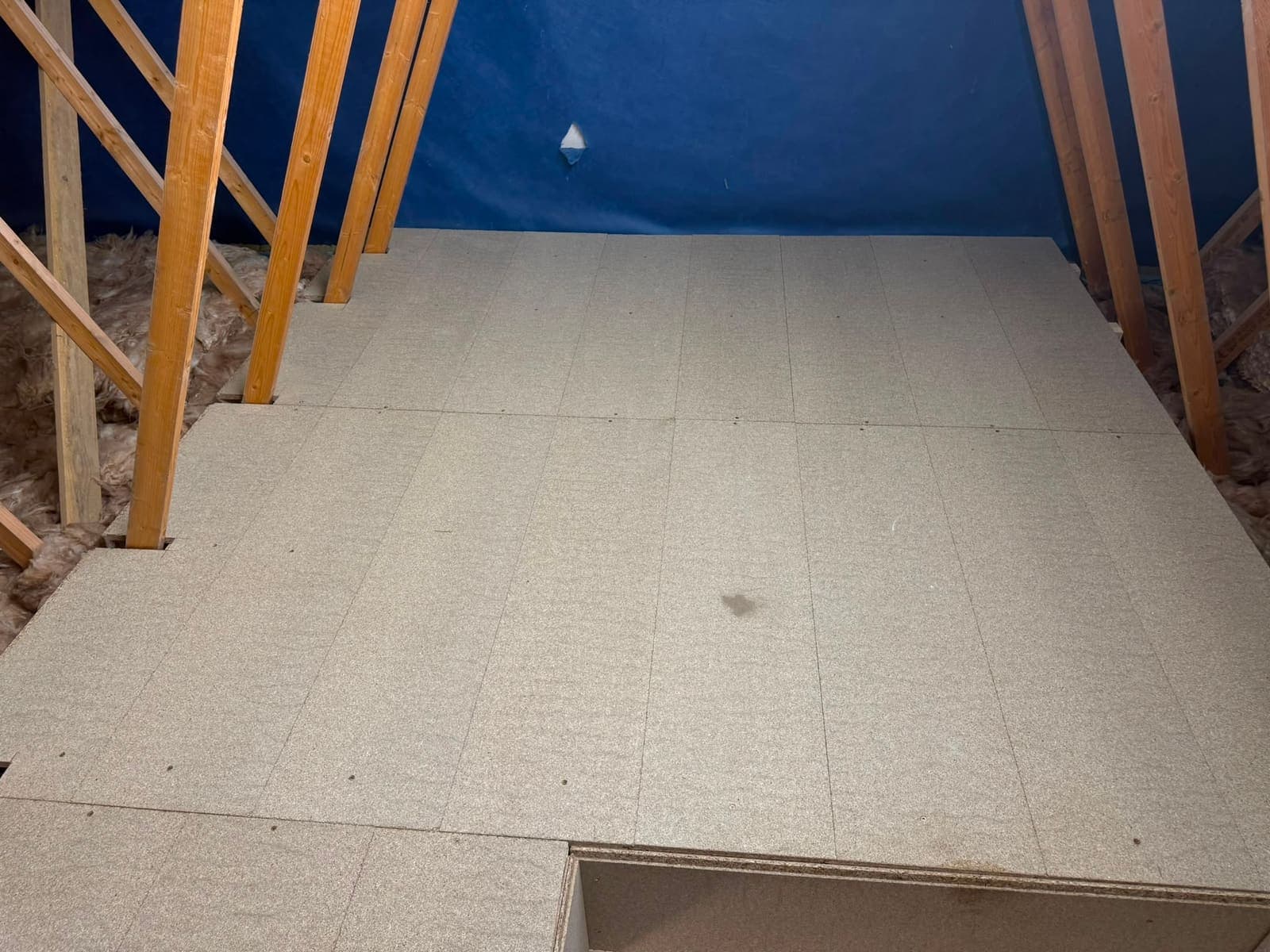 Boarded loft storage platform between the roof trusses