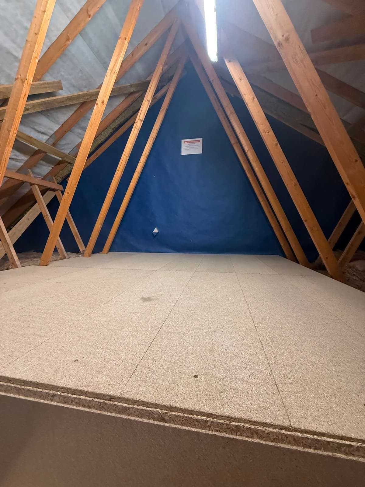 Raised boarded loft platform in a Kent new build